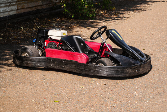 Red racing kart without a racer close-up in a parking lot of a circuit for a ring race