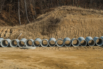 Concrete culverts on ground of new construction site.