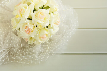 Bride's bouquet on a light wooden table.