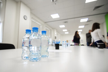 drinking water bottles at a meeting of colleagues in the boardroom in the office. seminar or training. corporate conference and business education