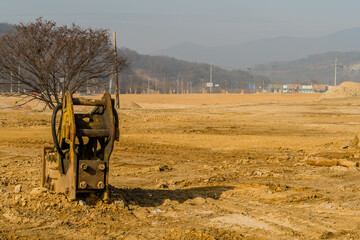 Backhoe attachments on ground