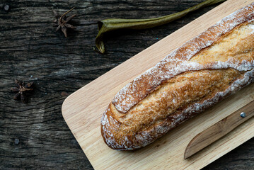A closeup top view of freshly baked traditional Italian Ciabatta breads prepared and cut in to slices on a wooden table read to be served