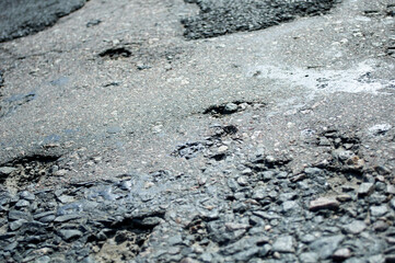 old half-ruined asphalt, semi-destroyed bumpy roadway
