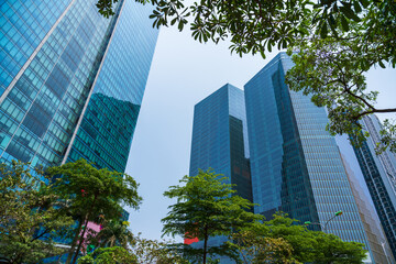 Closeup of top modern high-rise building in Dao Tan street, Hanoi, Vietnam. Mirroring of concrete...