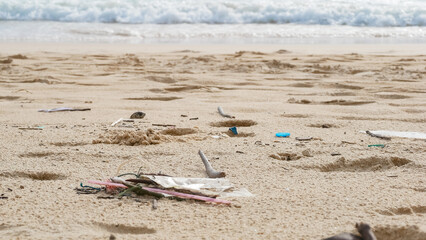 Fototapeta na wymiar Environmental pollution. Ecological problem. Garbages, plastic, and wastes on the sandy beach of tropical sea.