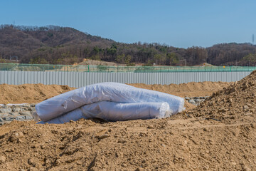 Rolls of white insulation at construction site.