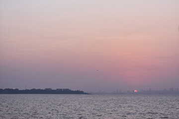 Fototapeta premium Sunset on the beach of Mumbai, captured from boat.
