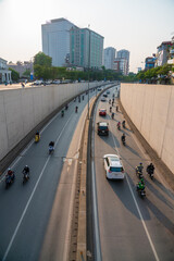 Hanoi traffic with vehicles running on Dai Co Viet crossing underpass tunnel exit