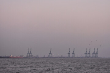 Naklejka premium Mumbai harbor captured from a boat, from a long distance.