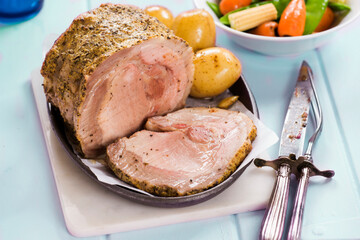 Mustard and herbs pork lion with baby potatoes and vegetables
