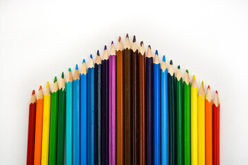 Many rainbow color pencils isolated on white background