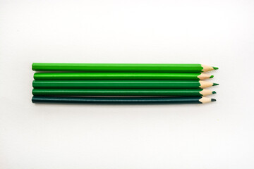 Many green color pencils isolated on white background