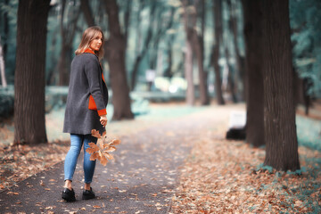 Fototapeta premium autumn view, people in the park on the background of autumn trees / beautiful autumn concept weather fall