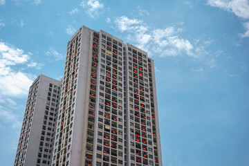 Fototapeta premium Modern apartment building with a lot of Vietnamese flags hanging on windows during importance special days in Hanoi, Vietnam