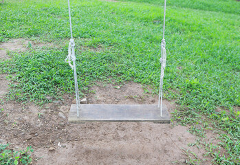 Empty swing placed in the garden