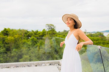 Portriat beautiful young asian woman happy smile around balcony with sea view