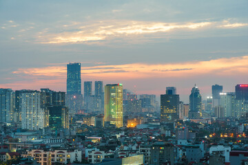 Fototapeta premium Hanoi cityscape at sunset with arising high buildings in Dong Da district