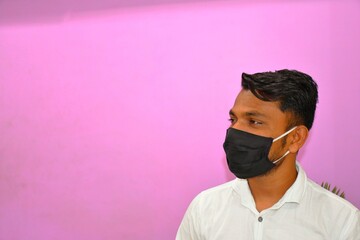 Obraz premium Masked man - protection against influenza virus. Indian man wearing mask for protect. man wear with protective face mask at home. Stop the virus and epidemic diseases.