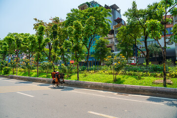 Hanoi street with green tree lines on Kim Ma street