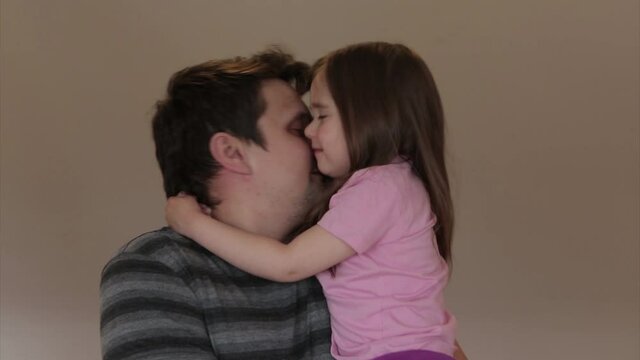 father's day. dad holds children in his arms and hugs them. girls kiss a man. I love you, dad!