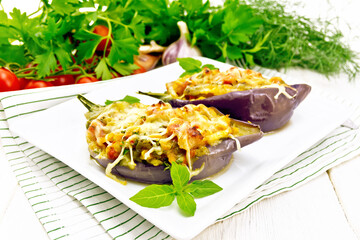 Eggplant stuffed brisket and vegetables in plate on light board