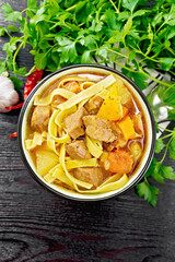 Lagman in bowl on dark board top