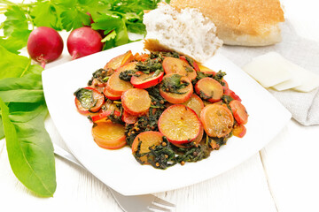 Radish with spinach and spices in plate on light board