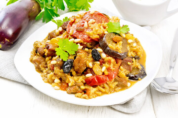 Rice with vegetables and chicken in plate on wooden board