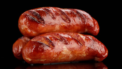 grilled sausage on black background