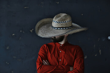 stern cowboy in a hat with brim, straw, retro vintage style, angry man wild west western