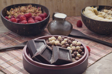 Delicious chocolate breakfast for cold winter morning - dark chocolate bar and crunchy chocolate balls with fresh farmer milk