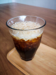 American cold coffee on a wooden tray in soft focus