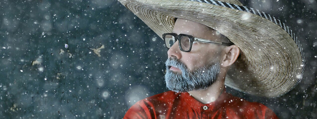 man in sombrero hat with brim, mexican style, latin america, snow cold winter christmas background