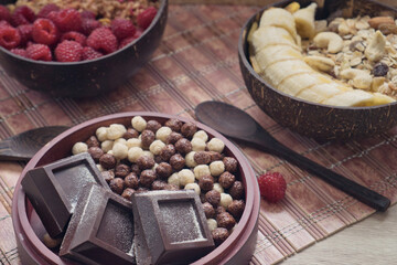 Delicious chocolate breakfast for cold winter morning - dark chocolate bar and crunchy chocolate balls with fresh farmer milk