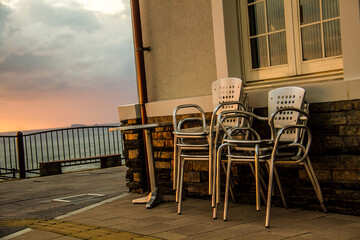 Multiple chairs lined up in the sunset