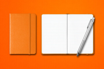 Orange closed and open notebooks with a pen isolated on colorful background