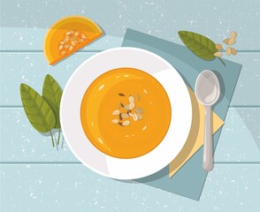 Pumpkin soup with spoon on blue  background. Top view. - 358722041