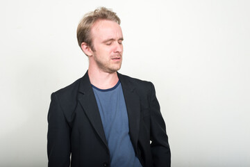 Face of stressed blond businessman with eyes closed