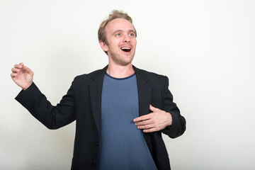 Portrait of happy handsome blond businessman singing