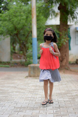 Little girl wearing self-made mask DURING COVID 19 PANDEMIC
