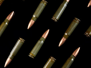 metal cartridges for hunting automatic weapons on a black background with a reflection
