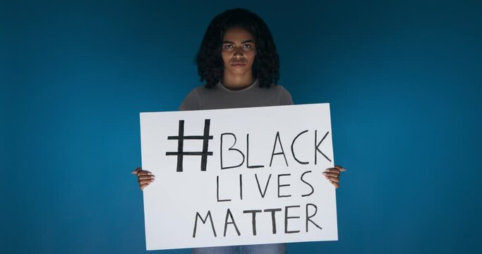 Upset African American girl holding strike placard
