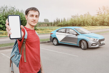 young person on a smartphone books a car or taxi in the carsharing app to get around the city. New...