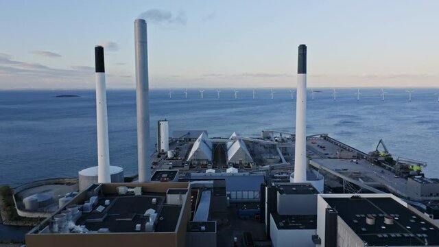 Buildings' Rooftops and a View of the Windmills Surrounded by Ocean Waters