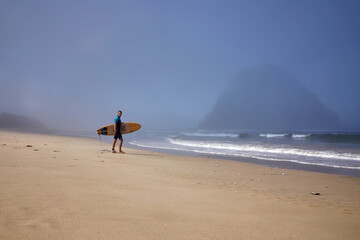 Fototapeta na wymiar Young guy surfer with board on the beach coast East Java, Indonesia