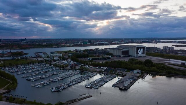 Harbor in Copenhagen with Boats Docked and Clouds in the Sky at Dawn