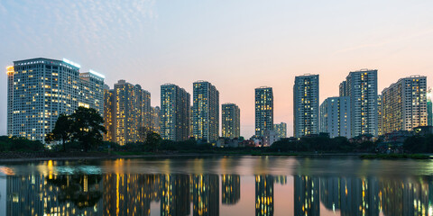 Fototapeta na wymiar Panorama of Hanoi city cityscape at sunset with reflection of apartment buildings skyline in 2020