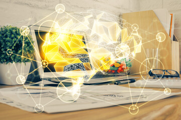 Double exposure of work space with computer and human brain drawing hologram. Brainstorm concept.