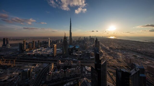 Dubai Downtown skyline all day timelapse with Burj Khalifa and other towers paniramic view from the top in Dubai, United Arab Emirates. clouds moves very fast.