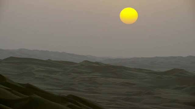 Beautiful sunset over mountains of sand dunes in the desert Dubai UAE , passing through them shoot over view of the desert dunes horizontal. helicopter, 6-axis, shootover F1, 8K